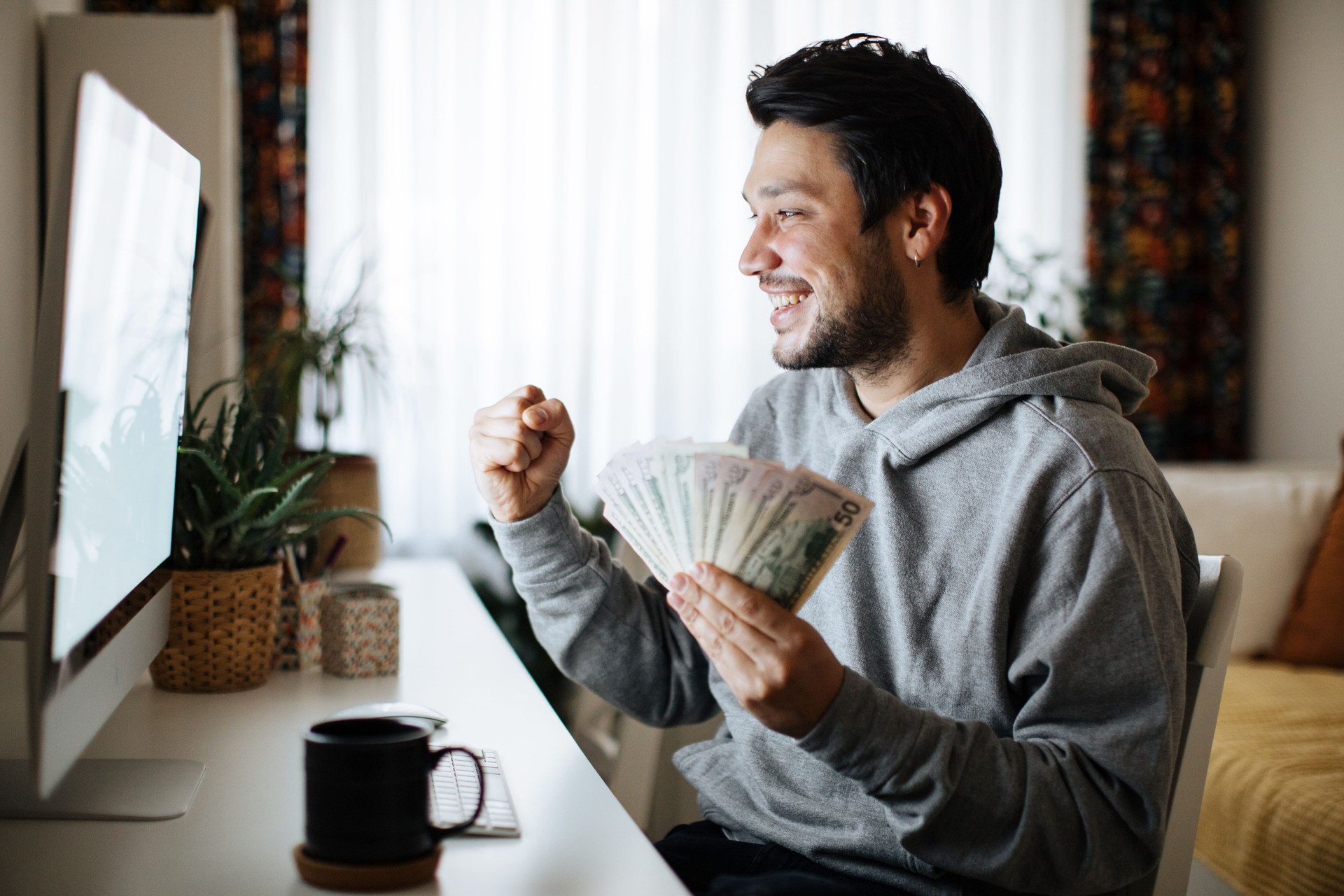 Man celebrating victory after making bets at bookmaker website